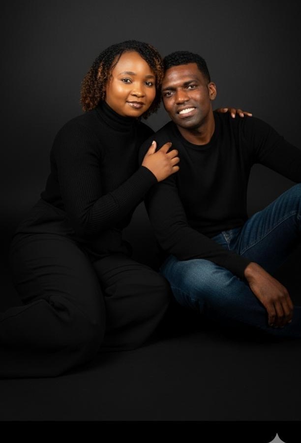 Steve and Shee, seated together in black outfits
